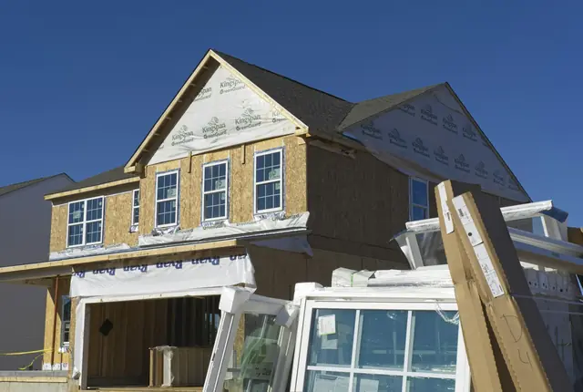 A house with new framing and plywood walls for more rooms